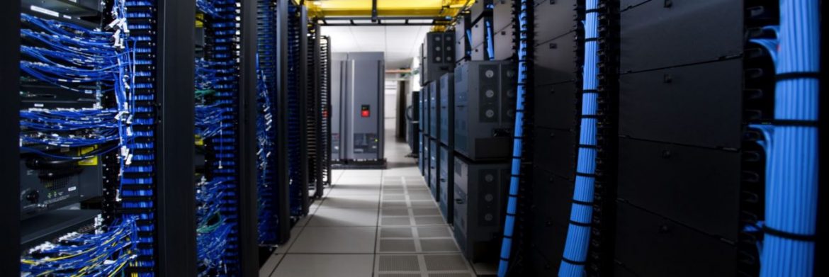 KGP Companies. A server room with black servers and blue wiring.