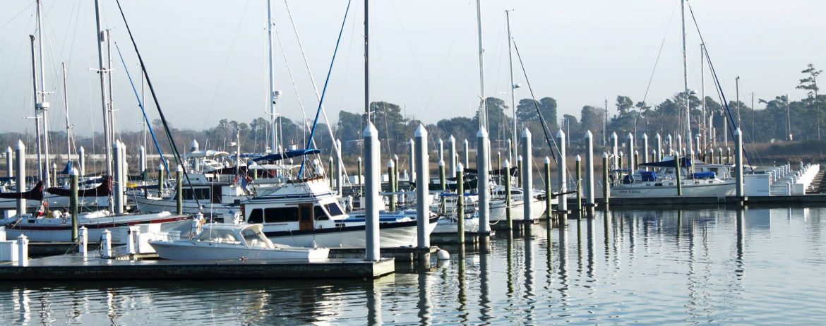 Baytown, Texas. A view of multiple boats tied up at a large dock.