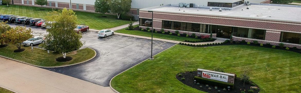 Mar-Bal Inc Renaissance Plant aerial view at an angle from the front, showing the building sign and cars parked out front.
