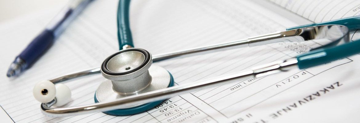College Students Health Care Coverage. A stethoscope and pen on an appointment book.