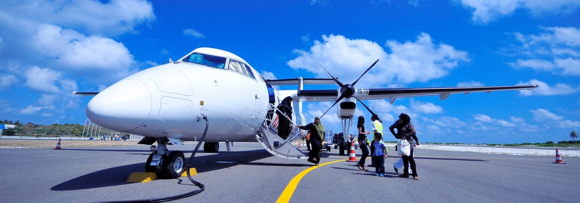 Chester County Airport. A plane parked on a runway with people boarding through a door on the side.