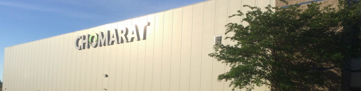 A large building with Chomarat in big letters on the side.