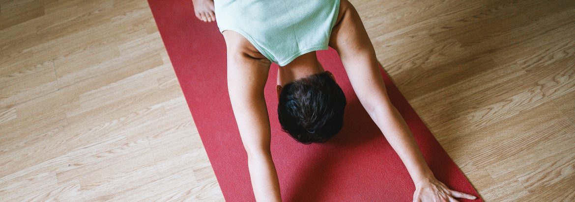A man stretching out on a yoga mat.