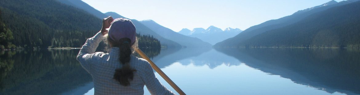 A woman paddling a kayak in the Cariboo Regional District of British Columbia.