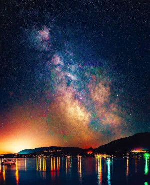 Cowichan Valley Regional District British Columbia stars in the night sky with lights reflecting on the water.