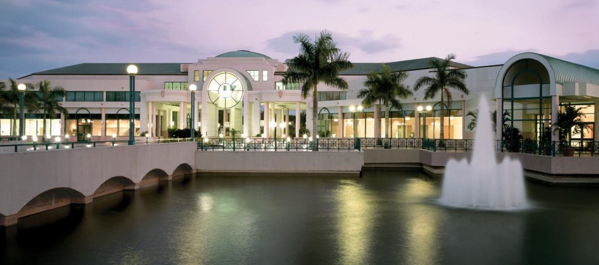 Sunrise Florida, a large public area with a water and a founder to the right of a walkway.
