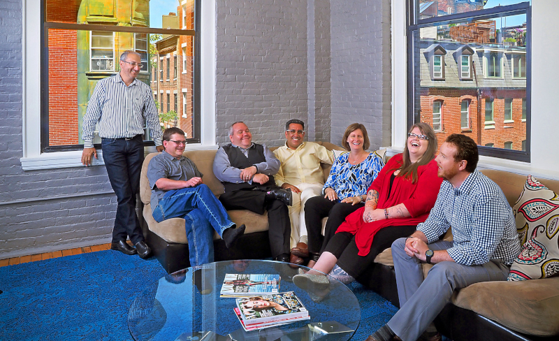 MaidPro executive team sitting on a couch.