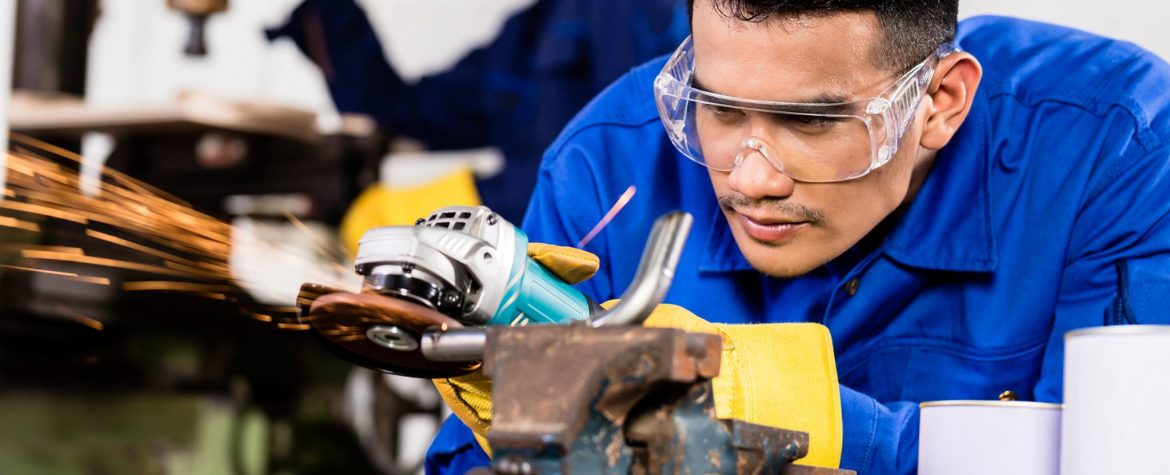 Cameron Manufacturing and Design Inc., a man using a grinder on something in a vice.