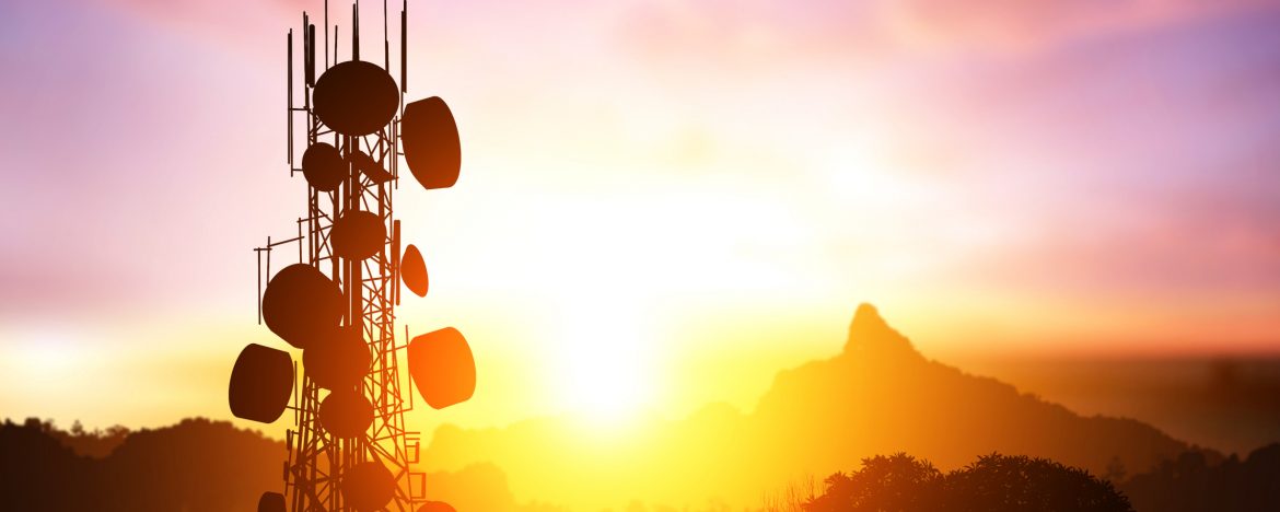 Reese Tower Services Inc. A tower with the sun close to setting behind it.