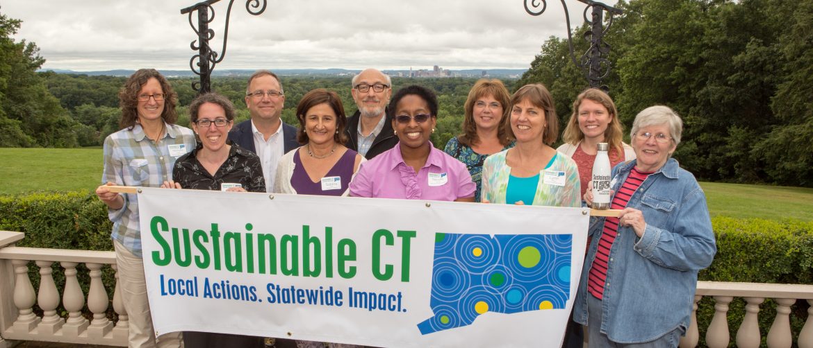Sustainable CT. A group of people hold up a Sustainable CT banner.