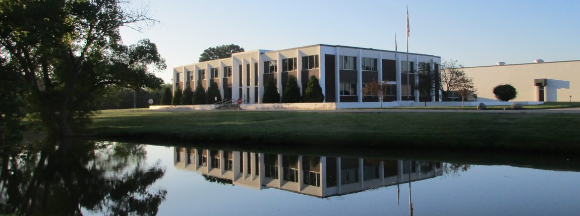 American Metal Technologies building with water in front.