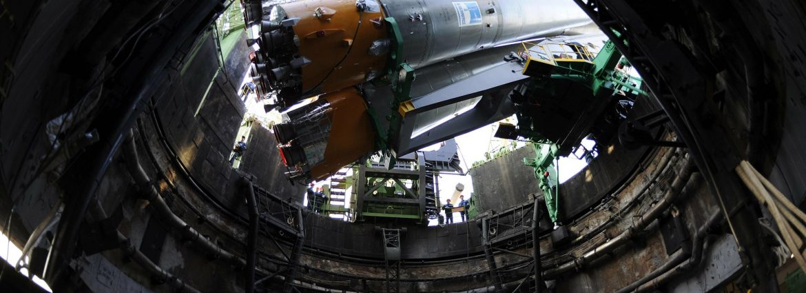 Rocket tilted at a launch site.