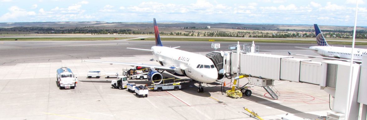 Billings Logan International Airport; Passenger Jet refueling and loading cargo and passengers at the terminal.