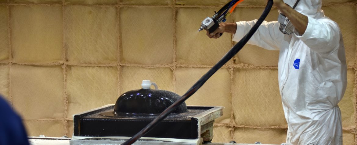 The International Cast Polymer Association. A person spray a sink.