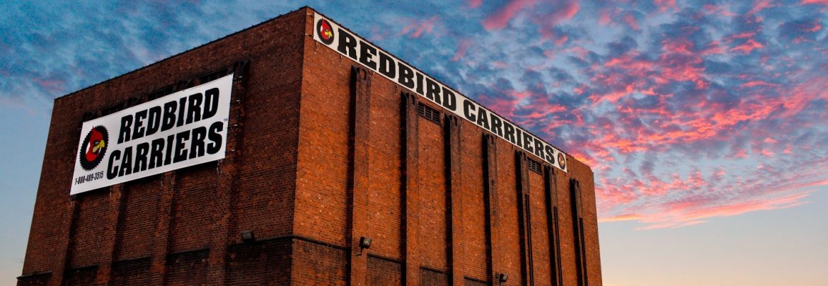 Redbird Carriers red brick building with two Redbird Carrier signs.