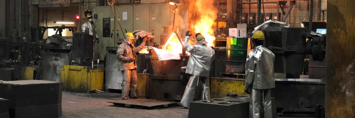 Stainless Foundry & Engineering Inc.; Men working around a smelter with red hot metal in a large building.