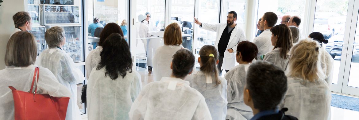 XYMOGEN group of people touring facility.