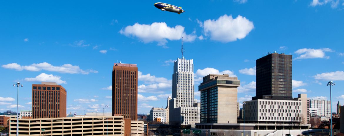 Akron, Ohio skyline with a blimp in the air.