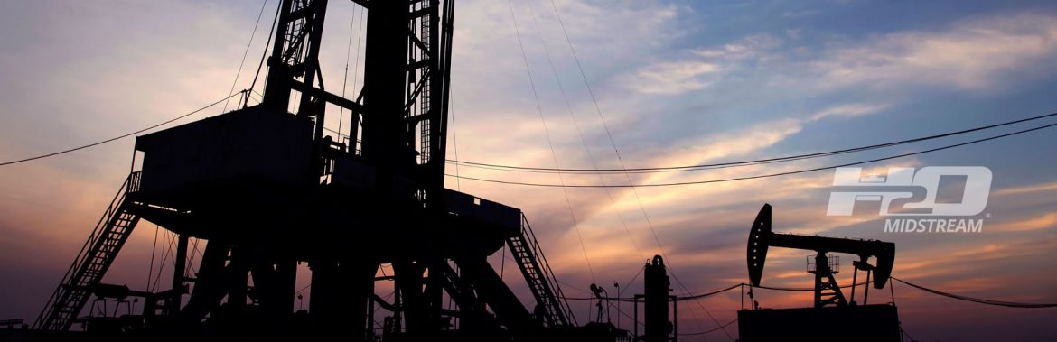 H2O Midstream. Oil well and oil pump at dusk.