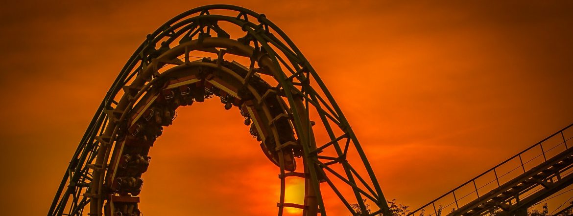 A roller coaster arching with orange sky behind. Amusement Parks Market Worth $70.83 Billion by 2025