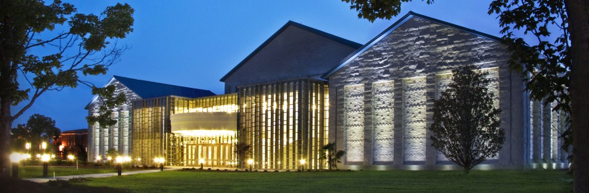 Florence PAC Exterior view with trees in the foreground and the lit up building behind. Located in Florence, South Carolina.