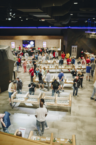 Planet 13 Las Vegas Dispensary interior from above showing people and display cases.