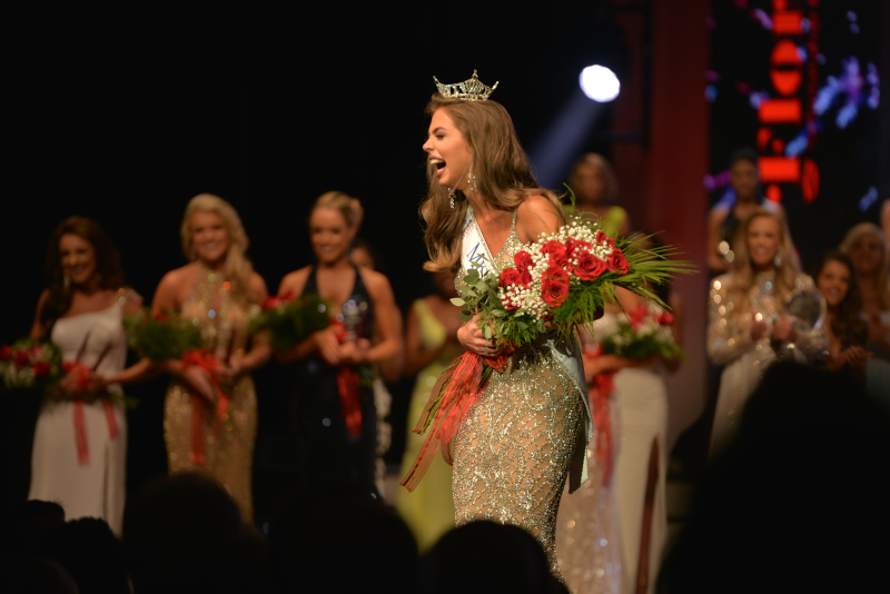 RP Funding Center, a woman accepting an award during a pageant.