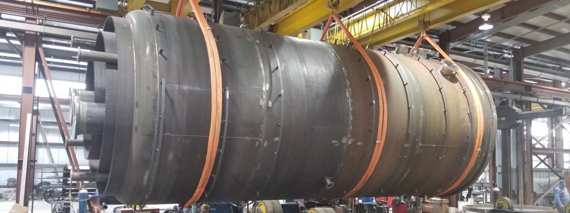 Thompson's Welding Services Inc. lift showing a large metal cylinder.