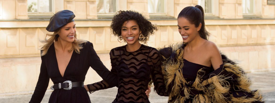 European Wax Center lifestyle image with three woman walking down the street showing off their legs.