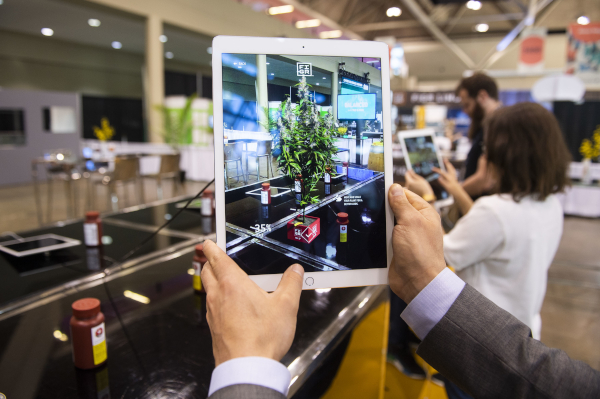 Lift & Co. Industry Day photo of a person holding a tablet showing a view of what it in front of them.