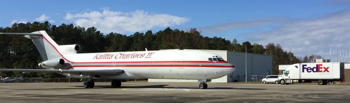 Rocky Mount-Wilson Regional Airport runway with a Kalitta Charters II jet in the foreground and a fedex truck behind.