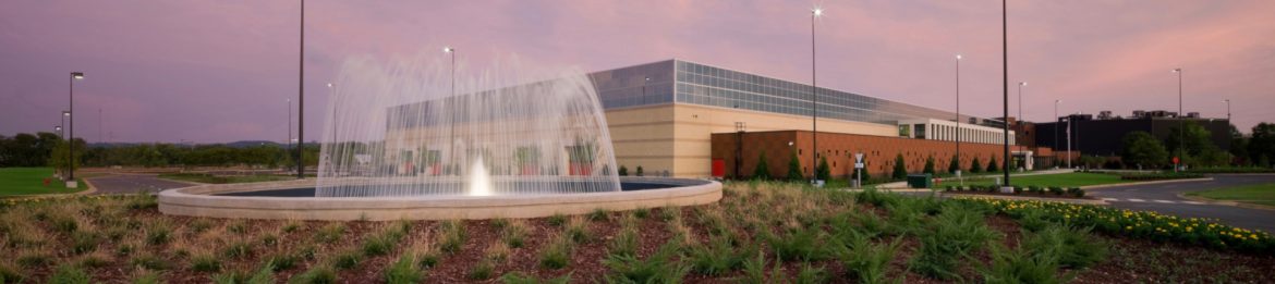 The Birmingham Crossplex exterior with a fountain on the left.
