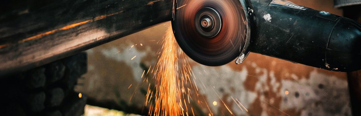 Harris Thermal Transfer Products/Harris Manufacturing stock photos of someone using a grinding disc tool on metal with sparks flying.