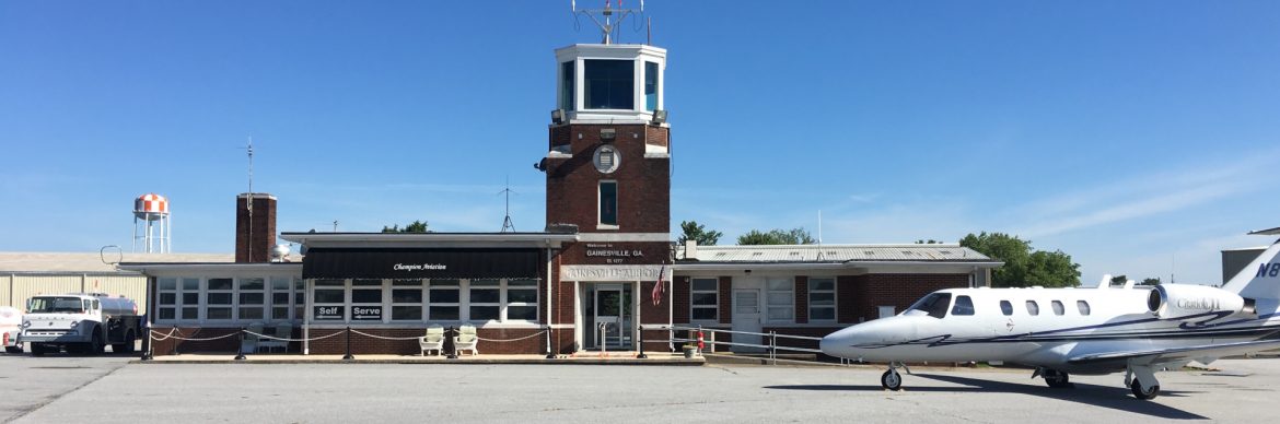 Lee Gilmer Memorial Airport terminal from the runway side with a Citation jet out front.