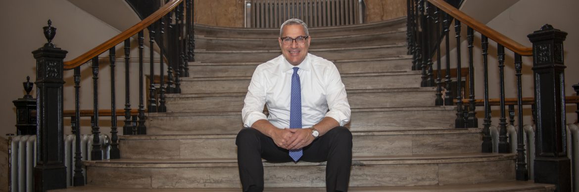 Englewood, New Jersey mayor Michael Wildes at city hall, sitting on the steps.