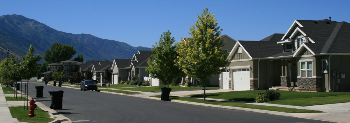Spanish Fork, Utah houses with a mountain and blue sky in the background.