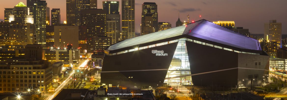 US Bank Stadium exterior at night with surrounding city.