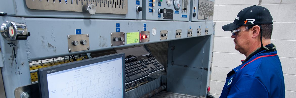 Unitech Services Group employee at a machine.