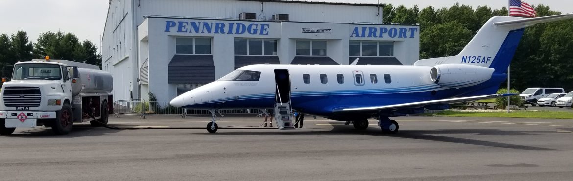 Pennridge Airport jet and truck out front of the terminal.