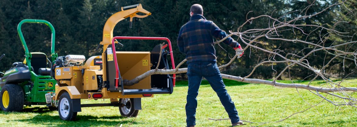 Wallenstein Equipment Inc. Phillip feeding a chipper.