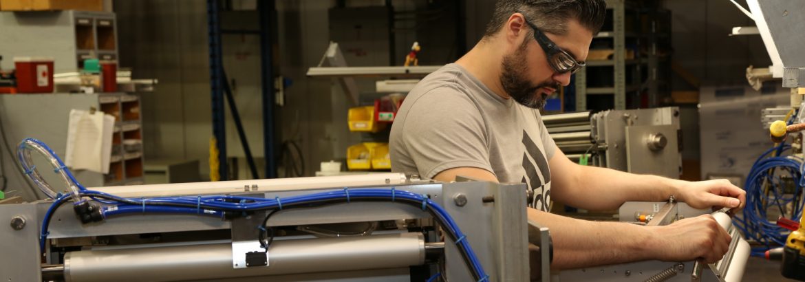 Butler Automatic splice head being assembled by an employee wearing protective glasses.