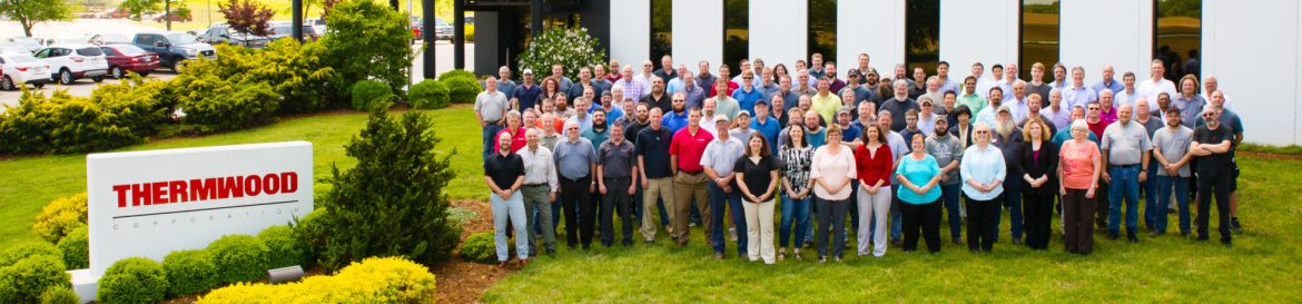 Thermwood Corporation group photo next to the Thermwood sign.