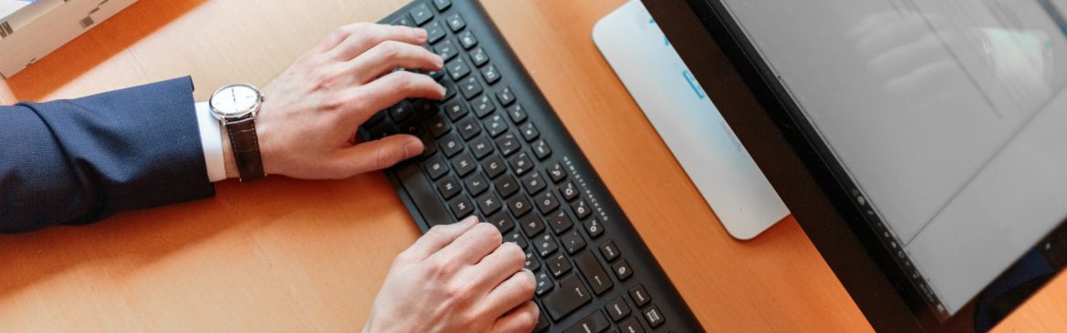 Hospitality Technology Next Generation HTNG person typing on a computer keyboard.