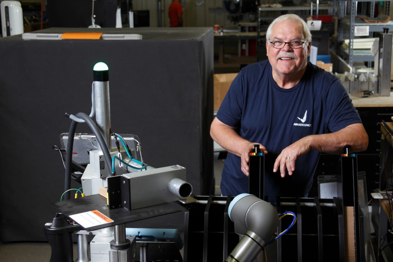 Sekisui Aerospace, formerly AIM Aerospace employee standing by equipment