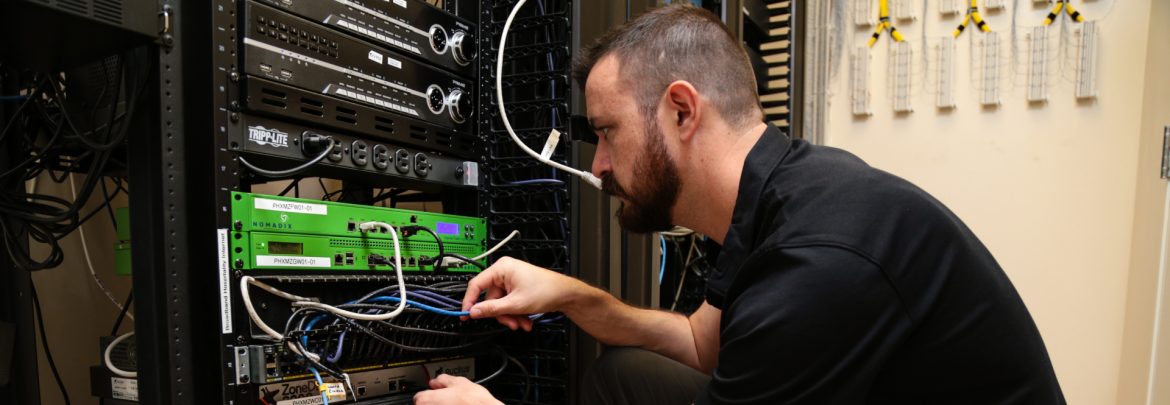 Broadband Hospitality Installation technician working on a server.