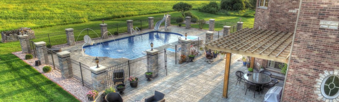 All Seasons Pools & Spas example of work showing a backyard pool at a home.