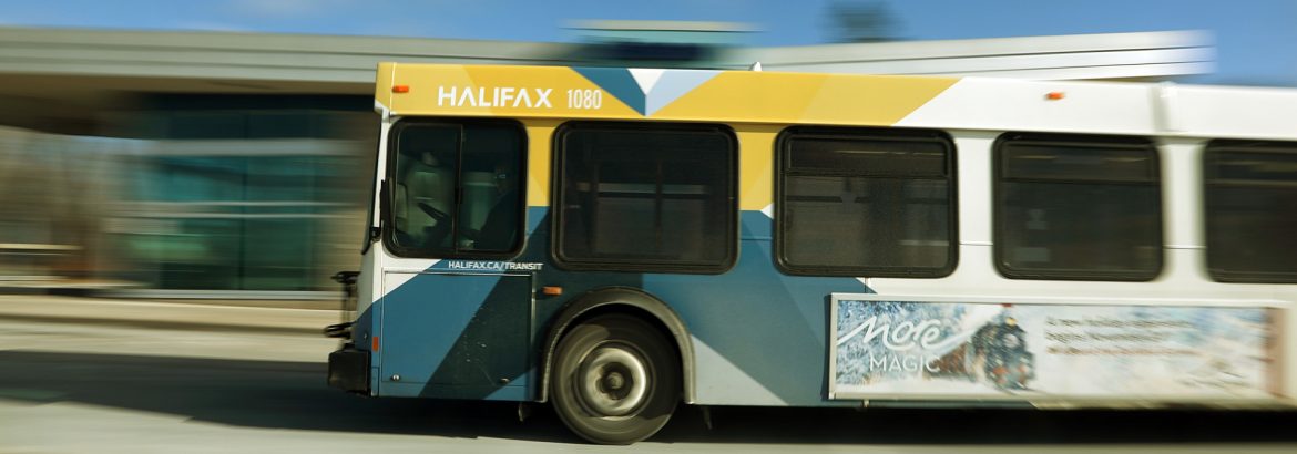 Halifax Transit bus with blurred background in motion.