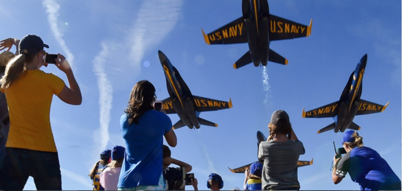 Terre Haute Regional Airport airshow with jets over head of other people taking photos.