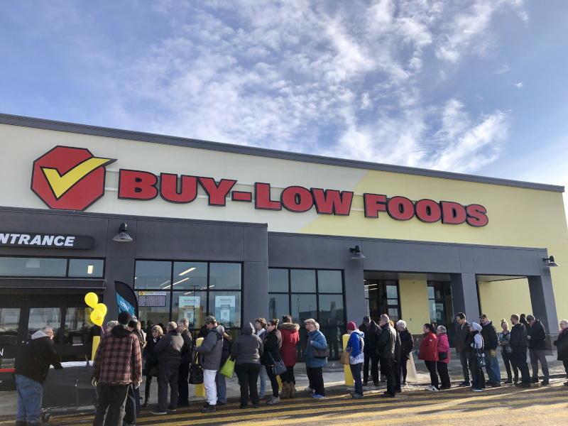 Warman, Saskatchewan Buy Low Opening event with a line of people out front.