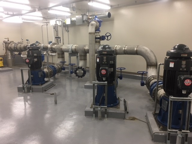 Warman, Saskatchewan new pump house interior with pumps mounted on cement floor.
